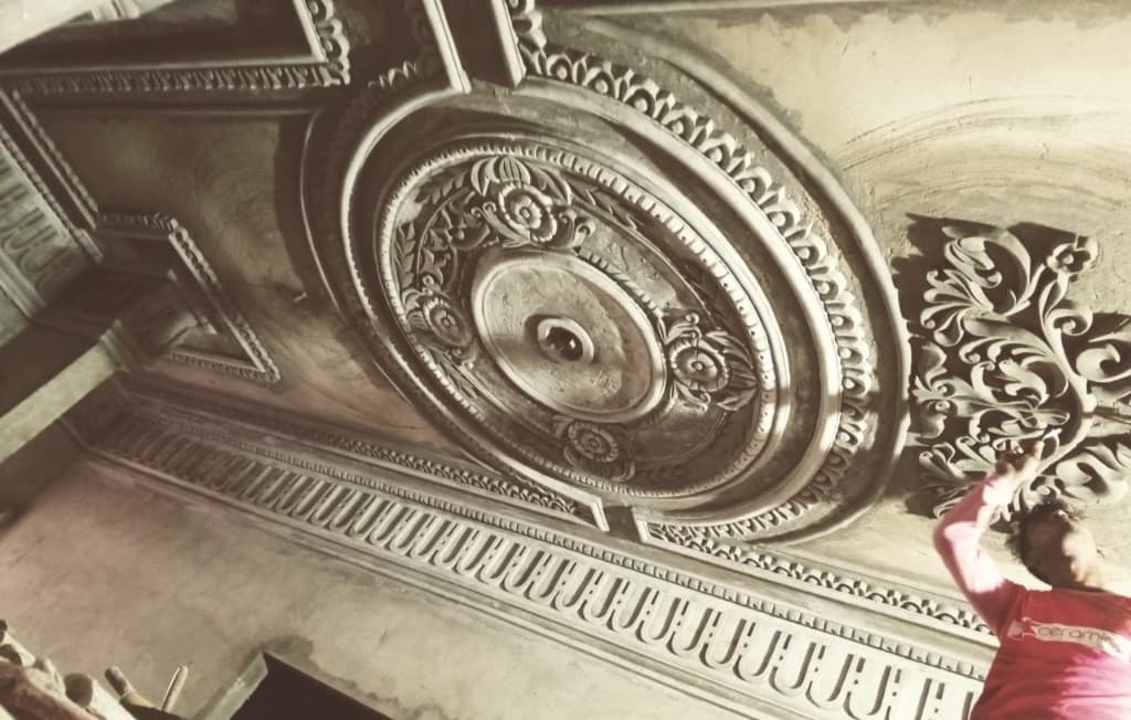 Ornate plaster cornice and ceiling medallion being finished in a Sylhet room.
